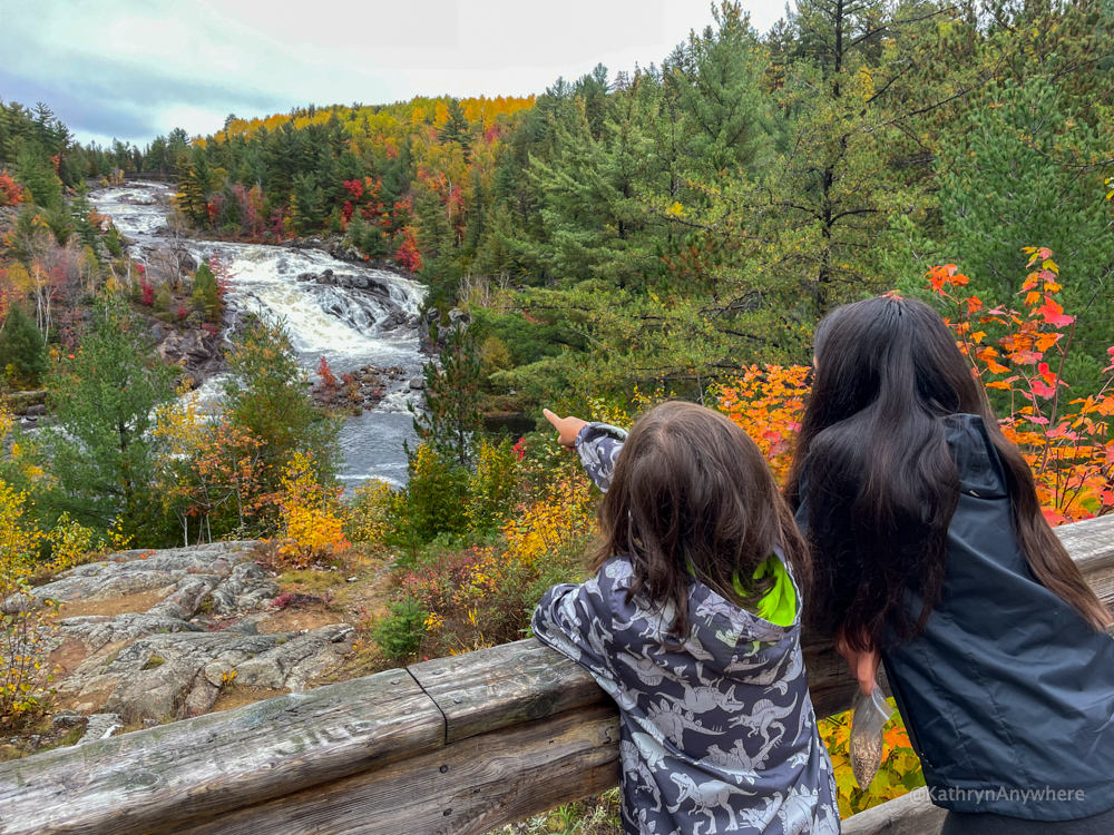 two children with their back turned to the camera at the AY Jackson lookout at Onaping Falls, Great Sudbury region