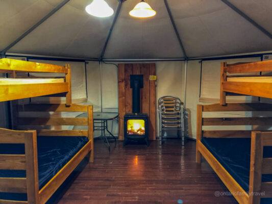 Yurt Interior MacGregor Point PP - bunk beds, chairs, table and electric fire